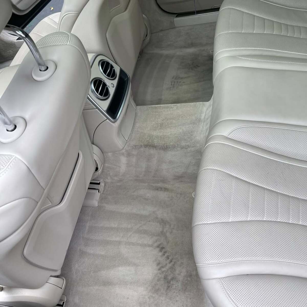 Heavily stained vehicle interior before professional deep cleaning treatment